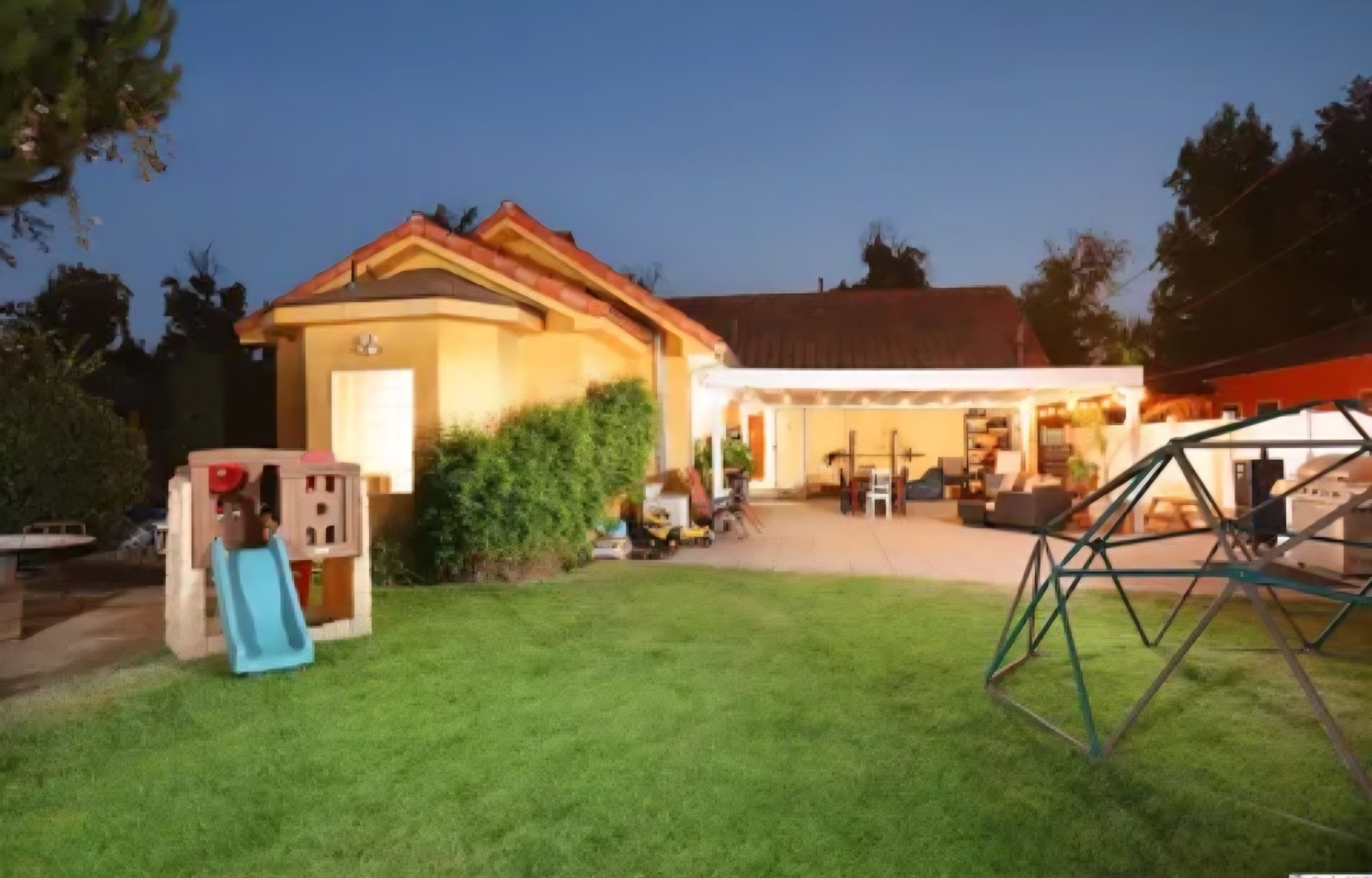 Burbank backyard with a lawn and illuminated covered patio