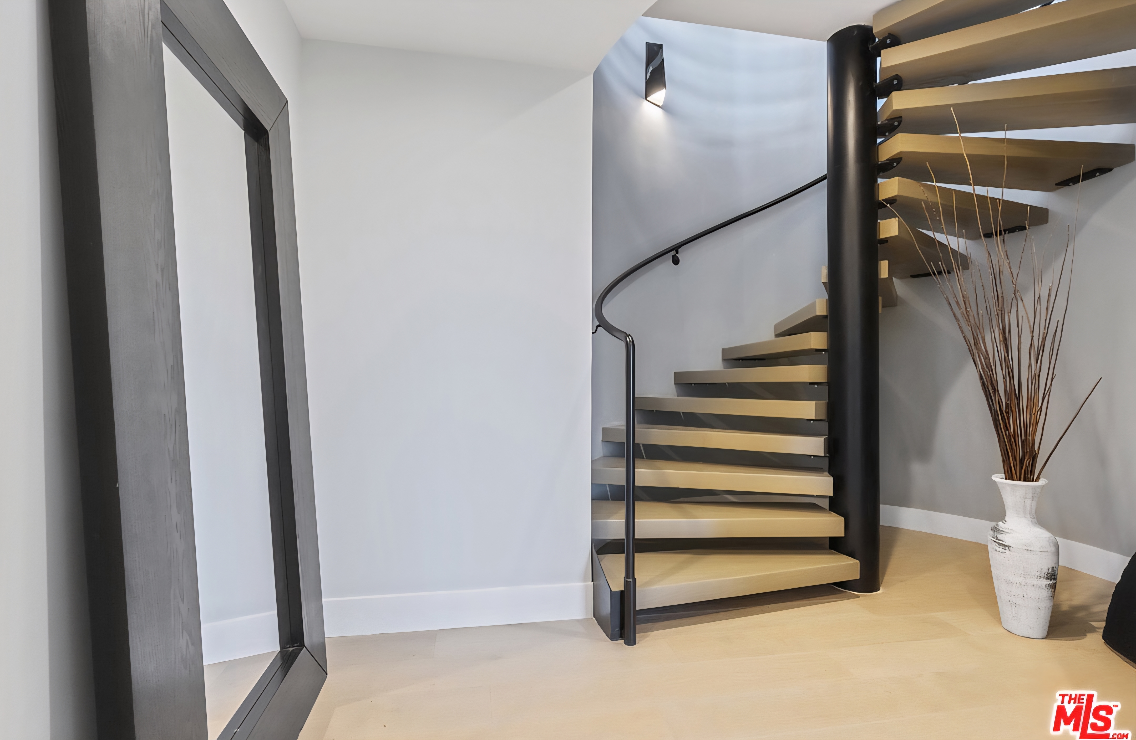Curved staircase with wood treads and black metal structure